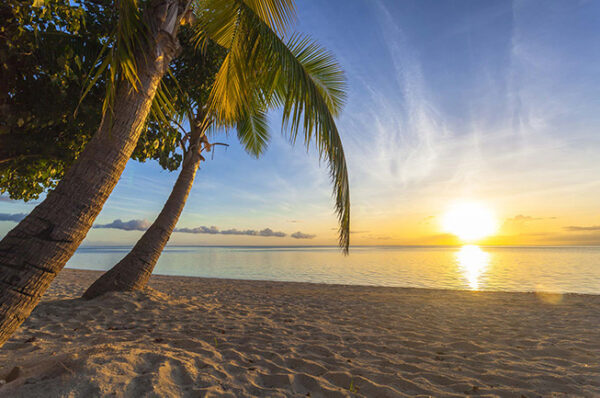 Fiji beach with sunset on horizon